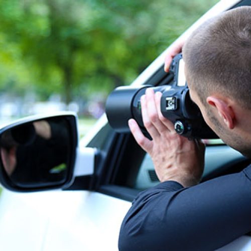 Man in car with photo camera