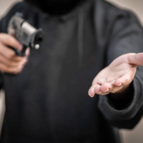 Gun and money in a hands. Bank robbery, Man carrying a gun to rob the money. To threaten with the gun man