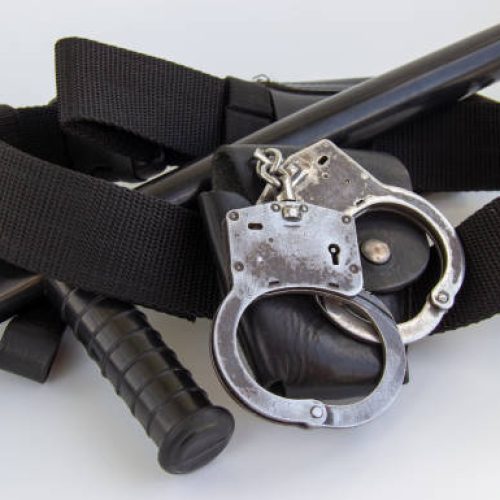 real police handcuffs with case and belt isolated on white background
